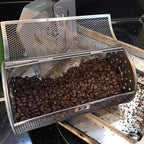 Open ROTO-Q 360 rotisserie (Round) basket filled with freshly roasted coffee beans.