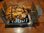 Whole roasted chicken on a ROTO-Q 360 rotisserie setup resting on a ROTO-Q 360 Premium Cooking Mat.