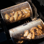 Two ROTO-Q 360 rotisserie baskets  (Round) cooking chicken wings on a grill.