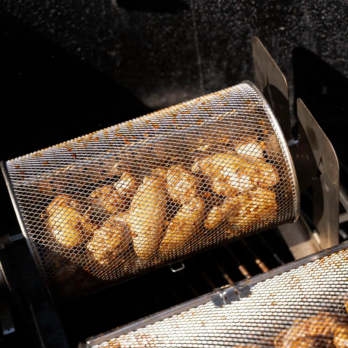 Chicken wings cooking in a round ROTO-Q 360 Rotisserie Basket XL