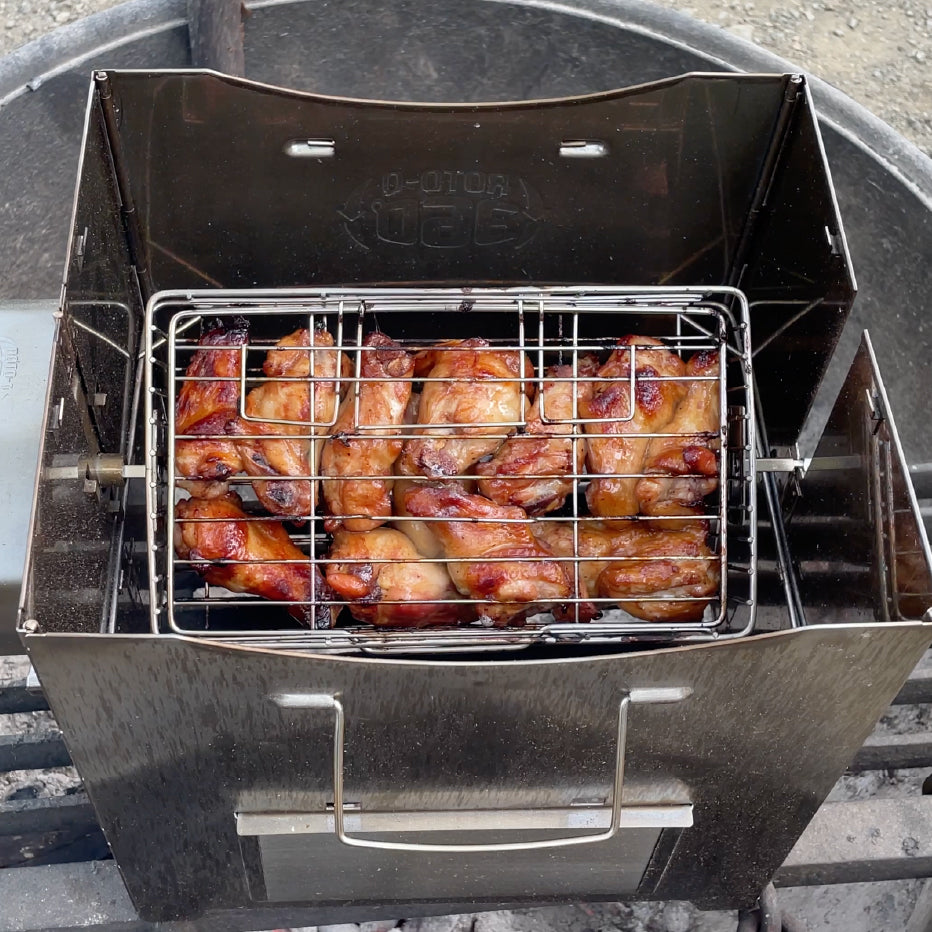 ROTO-Q 360 Rotisserie Cage (Flat) filled with chicken wings cooking inside a portable grill.