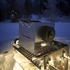 ROTO-Q 360 foldable stainless steel grill set up outdoors in the snow.