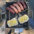 Sausages in a flatspin basket and scrambled egg toast cooking on a ROTO-Q 360 Foldable Grill