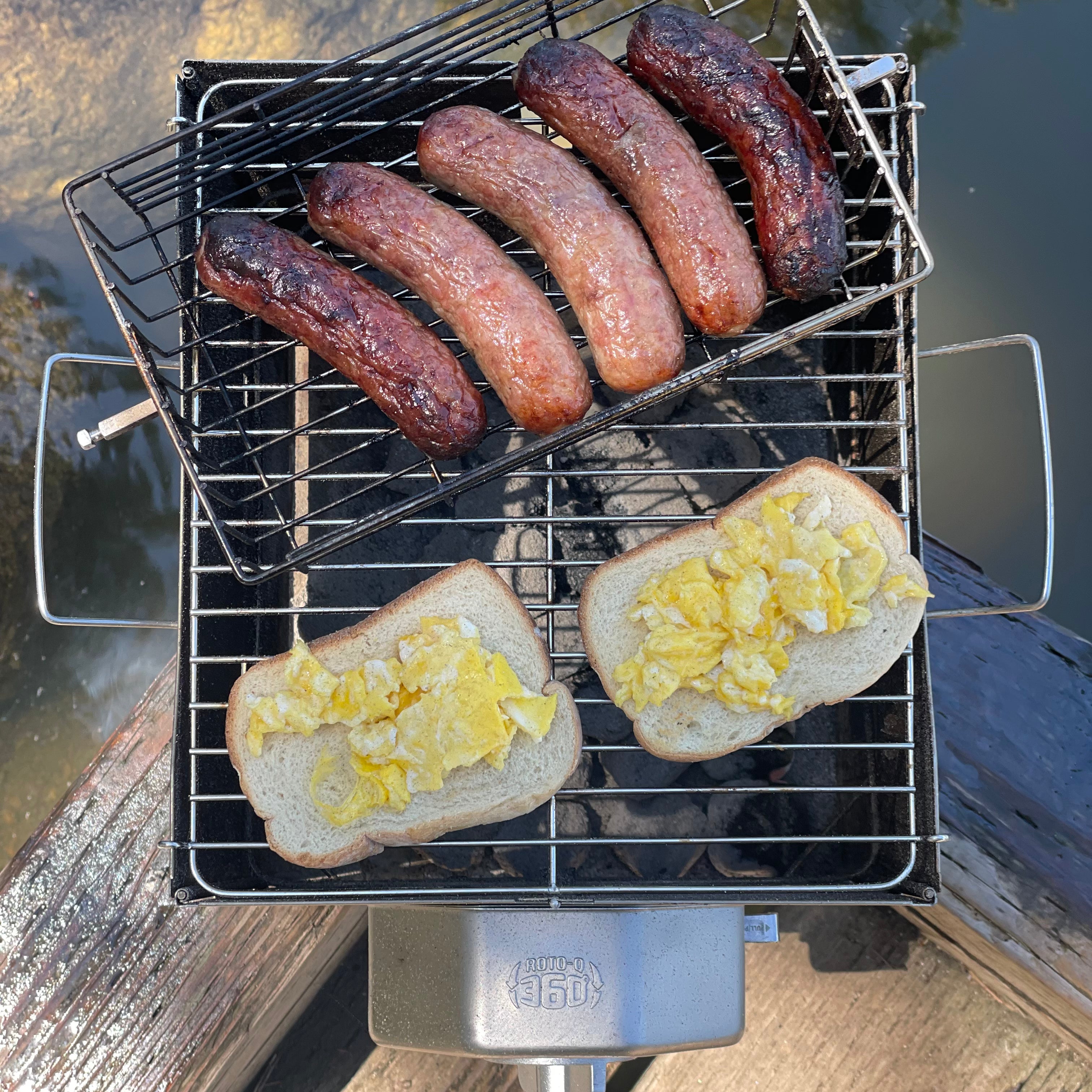 Sausages in a flatspin basket and scrambled egg toast cooking on a ROTO-Q 360 Foldable Grill