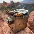Salmon fillets topped with lemon slices cooking in a cage on a ROTO-Q 360 grill.
