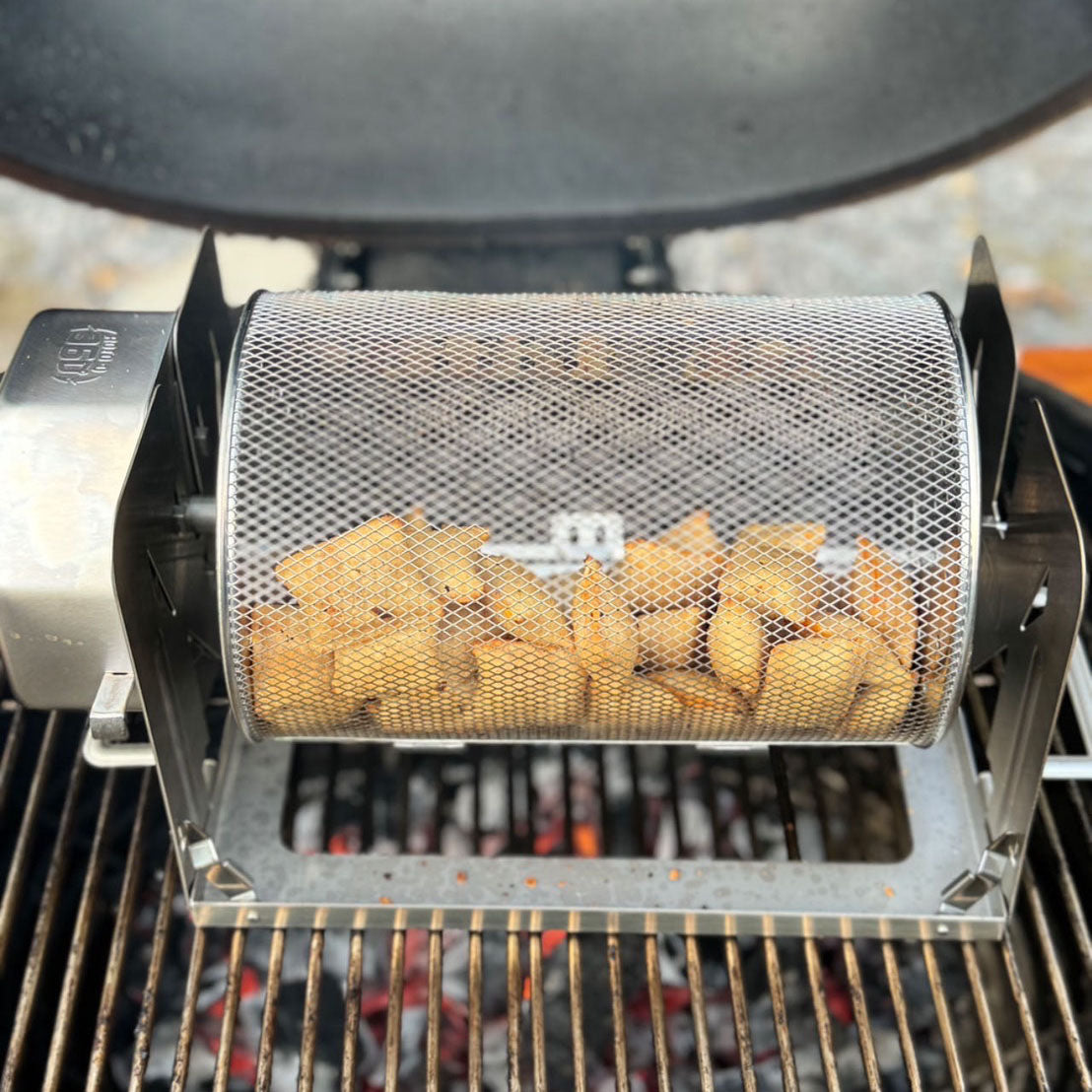Pizza rolls cooking in a ROTO-Q 360 Rotisserie Basket XL over a grill