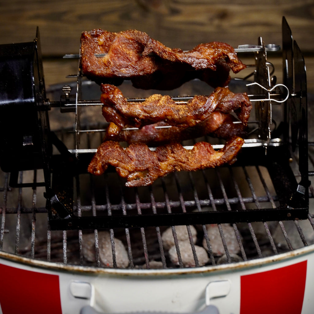 Meat grilling on a ROTO-Q 360 skewers over charcoal