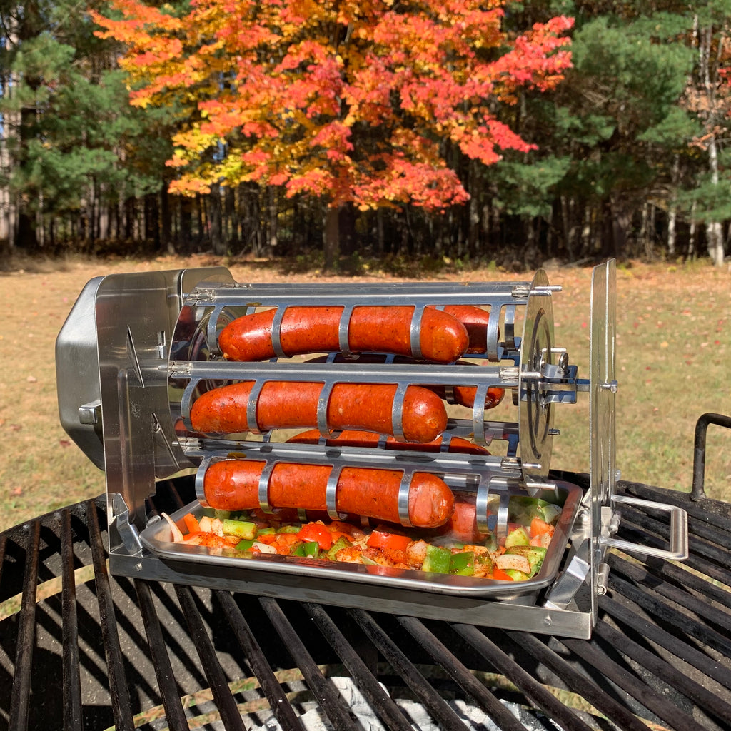 Sausages cooking in a ROTO-Q 360 hot dog rotisserie cradle on a grill