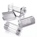 A stainless steel multi-functional rotisserie set including a grill basket, a skewer set, and a rectangular drip tray, displayed on a clean white background with soft reflections.