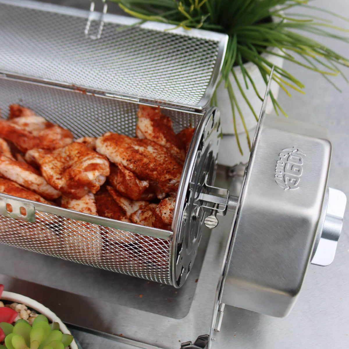 Seasoned chicken wings inside an open ROTO-Q 360 round rotisserie basket