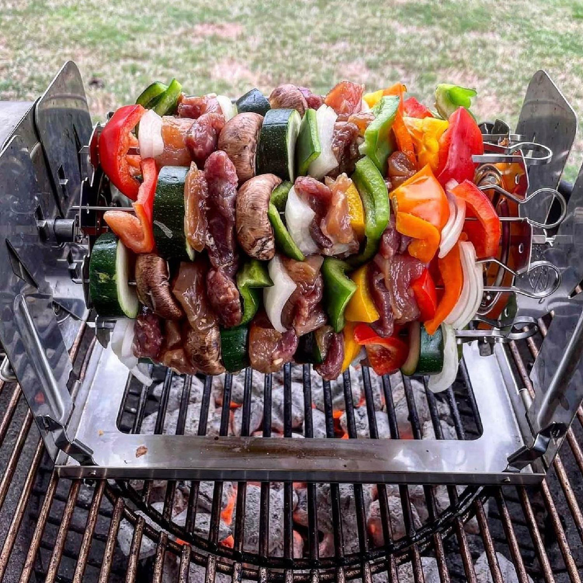 Kebabs grilling on a ROTO-Q 360 skewer set over charcoal