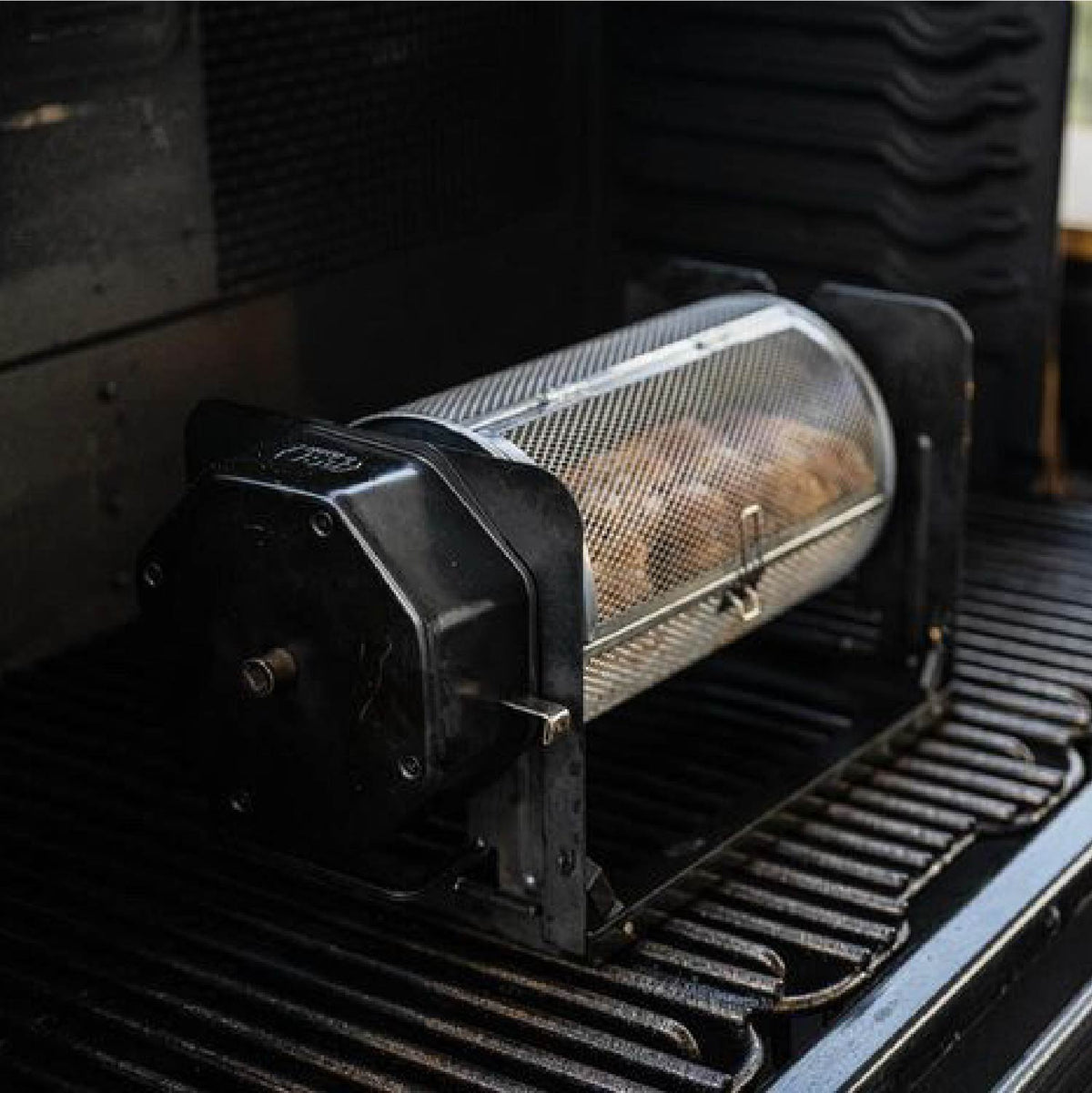 Food cooking in a ROTO-Q 360 round rotisserie basket on a grill