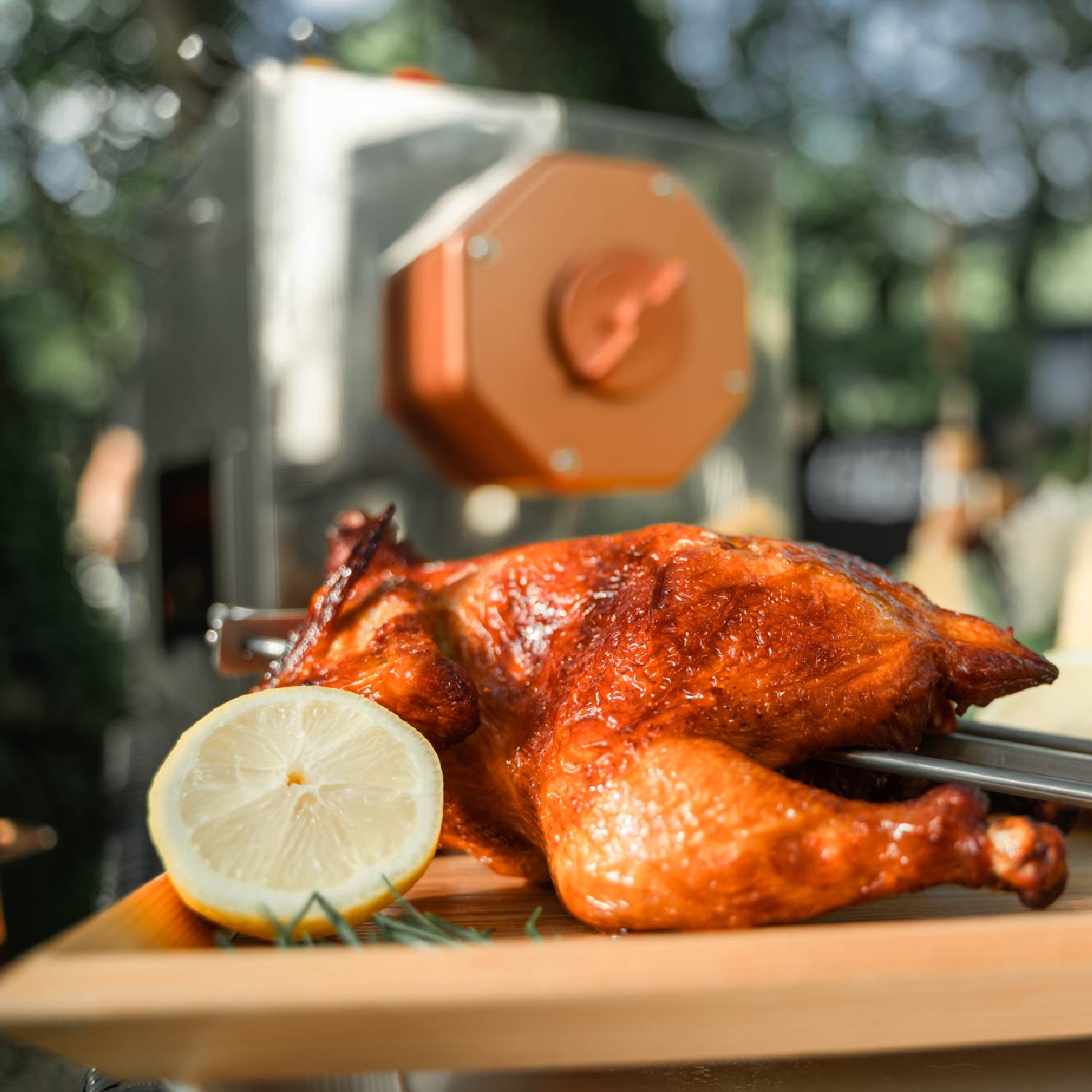Roasted whole chicken on a rotisserie rod