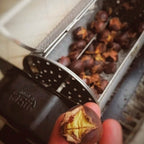 Hand holding roasted chestnut