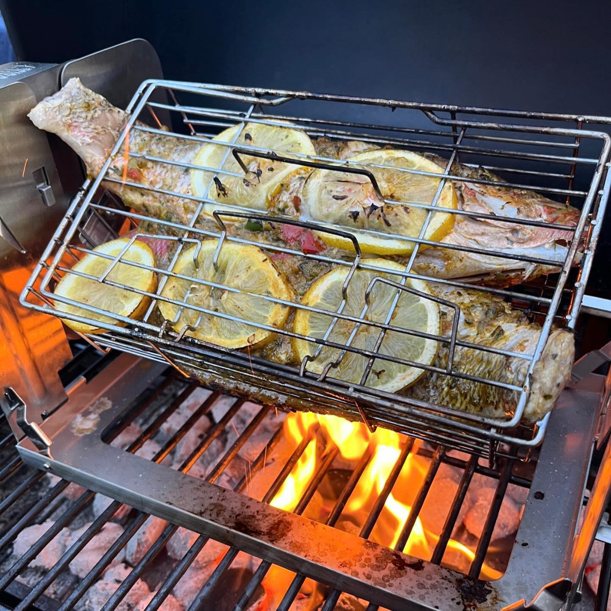 Fish grilling in a ROTO-Q 360 F over flames